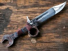 an old knife that is on top of a wooden table