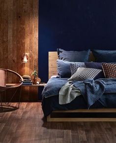 a bedroom with blue walls and wooden floors