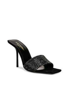 Find SAINT LAURENT Lucky Evening Mules In Black on Editorialist. Saint Laurent Lucky Evening Mules in Black Crystal embellished suede upper with leather sole. Made in Italy. Leather footbed. Square toe with pin heel. Approx 95mm/ 3.75 inch heel. SLAU-WZ947. 702680-0TP01-1012. About the designer: SAINT LAURENT has been influencing and revolutionizing the fashion industry since the debut of its iconic ‘Rive Gauche’ collection in 1966 - the couture house was the first to create a ready-to-wear capsule. The sleek, precisely tailored staples, like the signature biker jackets, transcend seasons and trends. Creative Director Anthony Vaccarello continues to honor the label’s illustrious reputation by reintroducing cult styles, including the ‘Lou’ handbag and ‘Tribute’ sandals. Luxury Leather Heels With Rhinestones, Evening Embellished Suede Heels, Embellished Suede Heels For Evening, Designer Leather Heels With Rhinestones, Fitted Leather Heels With Rhinestones, Luxury Suede Heels For Evening, Luxury Suede Heels For Night Out, Luxury Suede Evening Heels, Luxury Fitted Rhinestones Heels