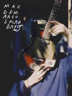 a woman is holding an electric guitar in front of her face with words written on it