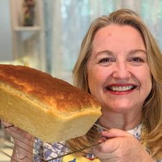 a woman holding a loaf of bread in her hands