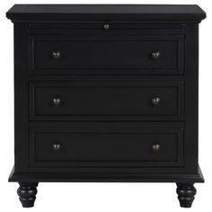 a black dresser with three drawers and two knobs on the bottom, in front of a white background