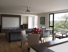 a living room filled with furniture and a flat screen tv sitting on top of a wooden floor