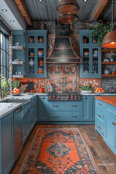 a kitchen with blue cabinets and an orange rug