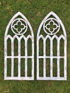 two metal windows sitting on top of green grass