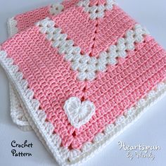 two pink and white crocheted squares on top of each other with a heart in the middle