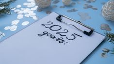 a clipboard with the date 2013 on it next to confetti and decorations