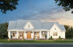 a white two story house with a front porch and large windows on the first floor