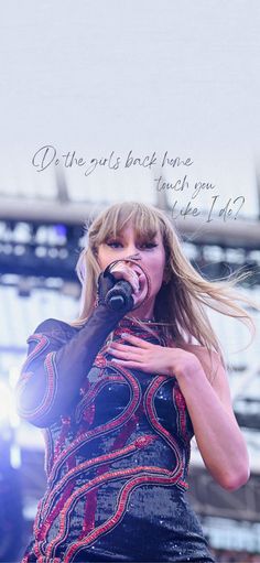 taylor swift singing into a microphone at a concert with the words, we've got us back home how do you touch your heart?