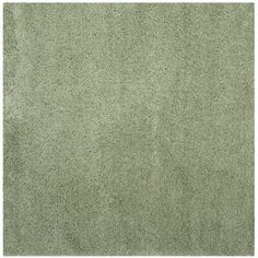 a green rug with small dots on the top and bottom, as well as an area for