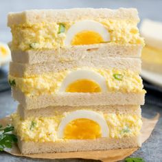 three slices of bread stacked on top of each other with eggs in them