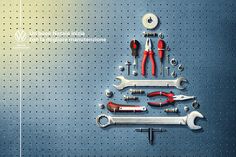 a christmas tree made out of wrenches and other tools on a pegboard background