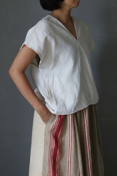 SASAKI-CHIHO(Antique fabric) "Antique linen short sleeves V-neck blouse"  Handmade by Chiho Sasaki Material:Antique linens, from France. Color: Ecru white Size: Neck to cuff : 9.8 inch (25 cm) Chest measurement :41.7 inch(106 cm) Shoulder to hem: 21.2 inch (54 cm) Model:5'2"(157 cm) Thank you White Bohemian Ramie Tops, Cream Linen V-neck Top, Bohemian Linen Short Sleeve Blouse, Bohemian Short-sleeve Linen Blouse, Bohemian Short Sleeve Linen Blouse, Linen Tops With Natural Dye And Short Sleeves, Short Sleeve Linen Tops With Natural Dye, Linen V-neck Blouse For Daywear, Traditional White Linen Blouse