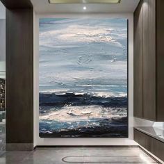 an abstract painting on the wall in a bathroom with dark wood cabinets and marble flooring