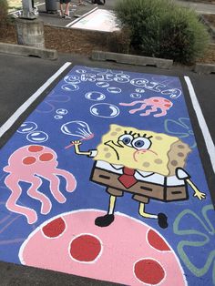 a chalk drawing of spongebob on the sidewalk