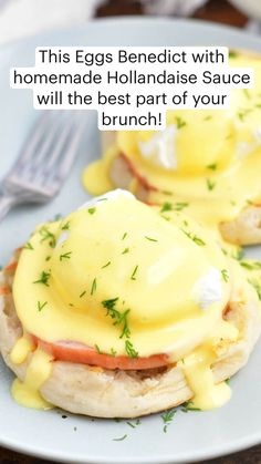 two english muffins covered in hollandaise and ham on a plate with a fork