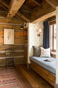 a room with wood paneling and a window seat