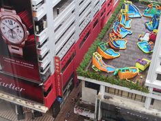 an overhead view of a large building with lots of fake water slides on the ground