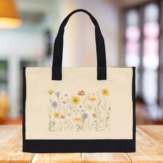 The Wildflower 100% Cotton Tote Bag. This Floral Tote Bag for Women features a captivating wildflower design that will add a splash of nature-inspired beauty to your daily routine. Measuring a generous 17” x 14” x 6”, this eco-friendly reusable bag is crafted from 100% cotton with reinforced stitching, ensuring both durability and elegance. It's roomy enough for beach days, picnics, errands, and everything in between, making it your new go-to bag for all your adventures. Beige Recyclable Bags For Daily Use, Eco-friendly Shoulder Bag With Reinforced Handles For Daily Use, Daily Use Tote Bags With Reinforced Handles, Tote Bags With Reinforced Handles For Daily Use, Eco-friendly Bags With Reinforced Double Handles, Eco-friendly Bags With Reinforced Handles For Daily Use, Eco-friendly Bag With Reinforced Handles For Daily Use, Beige Recyclable Bag For Everyday, Recyclable Canvas Shoulder Bag For Daily Use