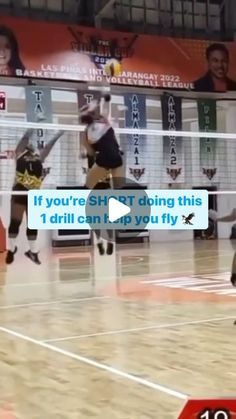 the volleyball players are jumping to hit the ball