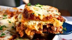 a close up of a plate of lasagna casserole with meat and cheese