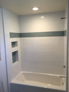 a white bath tub sitting inside of a bathroom