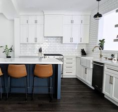 a kitchen with white cabinets and blue counter tops