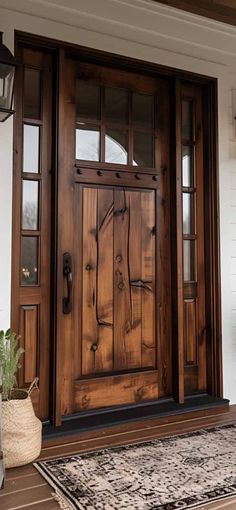 a wooden front door with two sidelights