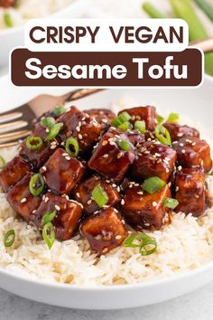 a white plate topped with rice and tofu covered in sesame seeds, garnished with green onions