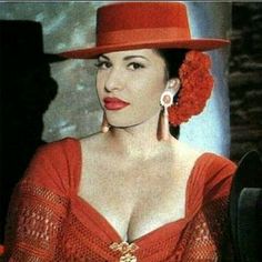 a woman wearing a red dress and hat