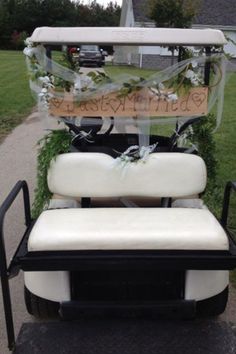 a white and black golf cart with flowers on it