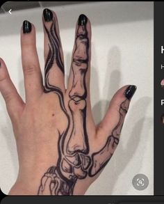 a woman's hand with black and white designs on it