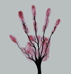 a tree with pink leaves is shown in the shape of a handprint on a white background