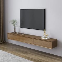 a flat screen tv mounted to the side of a wooden shelf in a living room