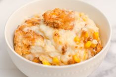 a bowl filled with macaroni and cheese on top of a marble countertop