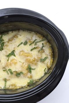 a crock pot filled with food sitting on top of a table