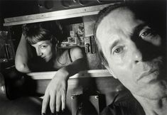 black and white photograph of man and woman in kitchen