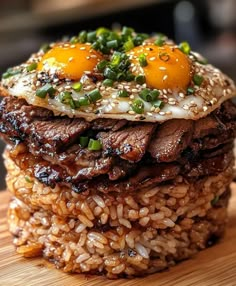 some food is stacked on top of each other with eggs and meat in the middle