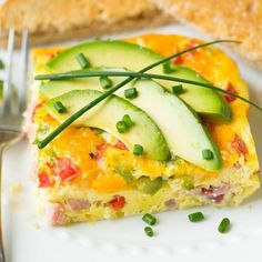 an omelet with cucumbers and green onions sits on a white plate