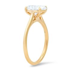 a yellow gold ring with an oval cut diamond