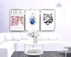 a living room filled with white furniture and pictures on the wall