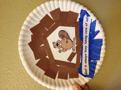 a paper plate that has been made to look like a bear holding a tennis racquet