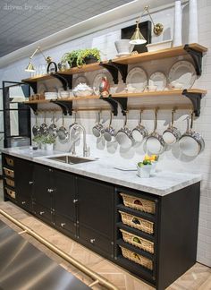 a kitchen with white counter tops and black cabinets