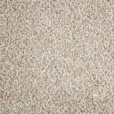 a close up view of a beige carpet with speckled brown and white colors on it