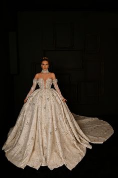 a woman in a wedding dress is posing for the camera