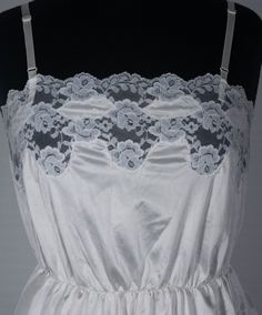 Here's a sweet and lovely vintage camisole you'll adore. This late 70s / 80s crossover brand cami has an original Ashley Taylor label and great boho style. You'll love feeling groovy in this hourglass top and you'll love wearing it with your other period collectibles. This figure-flattering ivory colored, lace trimmed camisole top is in excellent condition with signs of wear/use and portion of stretched waistband that still works and stretches in and out just fine - see last close up picture. Th Vintage Fitted Sleeveless Camisole, Vintage Fitted Spaghetti Strap Tops, Fitted Vintage Camisole, Vintage Fitted Tank Top With Spaghetti Straps, Fitted Vintage Tank Top With Spaghetti Straps, Vintage Spring Camisole, Vintage Lace Trim Camisole For Spring, Vintage Lace Camisole For Spring, Vintage Spring Camisole With Spaghetti Straps