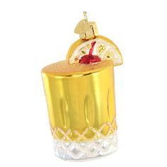 an ornament shaped like a gold cupcake with a cherry on top