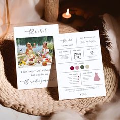 two cards that are on top of a table next to a candle and some feathers