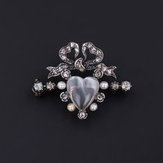 You'll fall in love with this moonstone brooch! This antique brooch dates to the late Victorian era (circa 1880-1900).  It is silver topped 14k gold with a heart shaped moonstone surrounded by glittery diamonds and pearls.   The piece measures 1 inch from top to bottom by 1.25 inches wide, and it is in very good condition. We have many other fantastic offerings of fine jewelry posted on our Etsy store, so please consider browsing our other items. We send all items in individually packaged gift b Engagement Ring Necklace, Diamonds And Pearls, Antique Turquoise, Heart Shaped Jewelry, Jewelry Post, Antique Brooches, Heart Brooch, Silver Tops, Gold Brooches