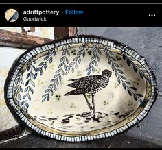 a bowl with a bird painted on it